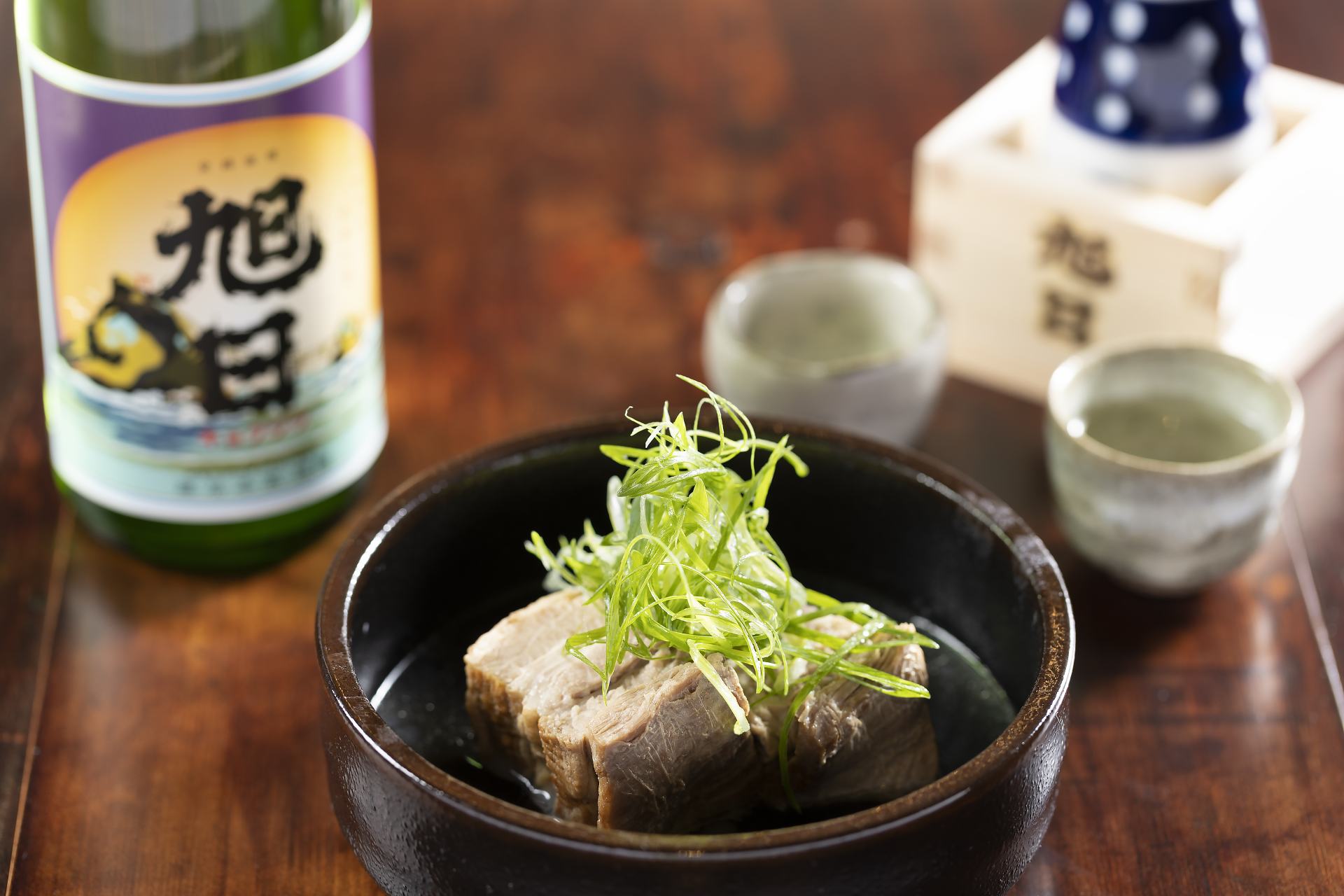 Small plates to pair with sake, like tender pork belly simmered in a light Japanese-style broth for 880 yen to try. 