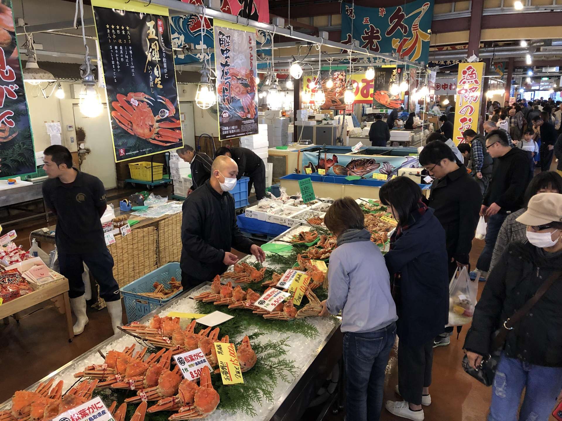 The lively market with customers.