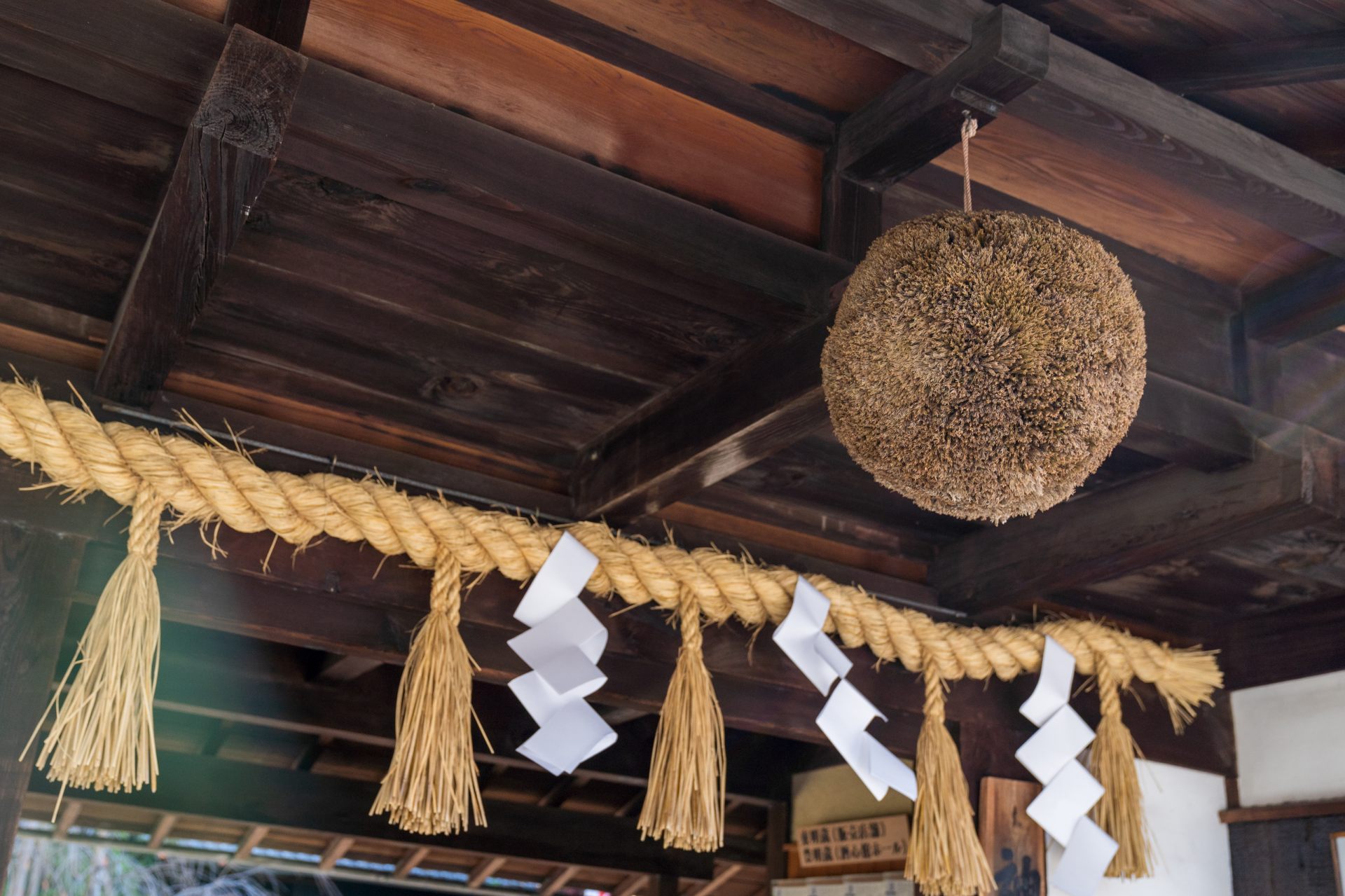 A ball made of cedar branches called a sakabayashi is suspended from the eaves.