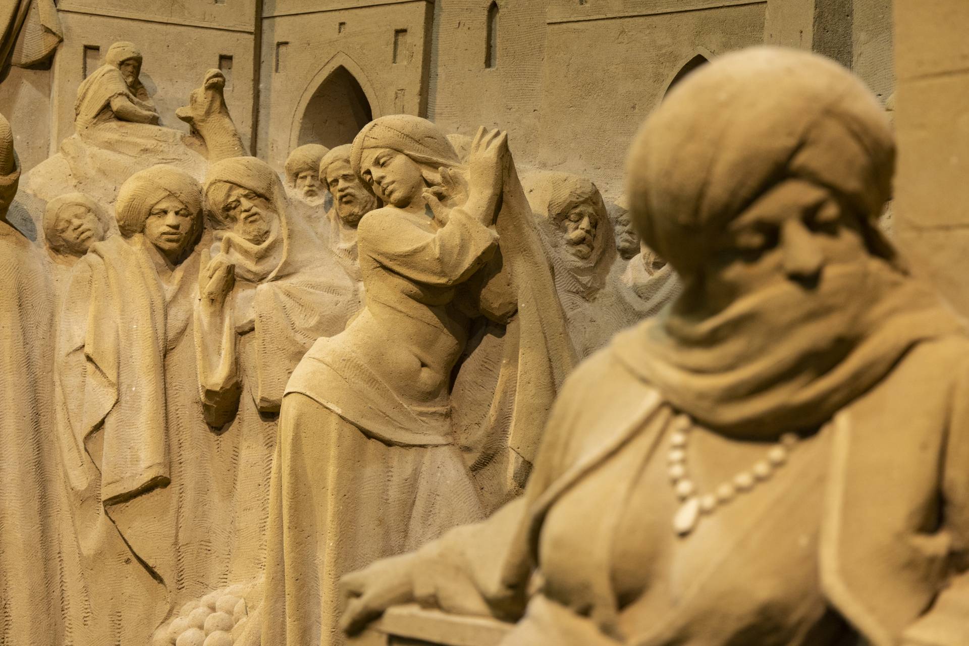 A statue with remarkably intricate expressions, almost unbelievable that its made of sand.