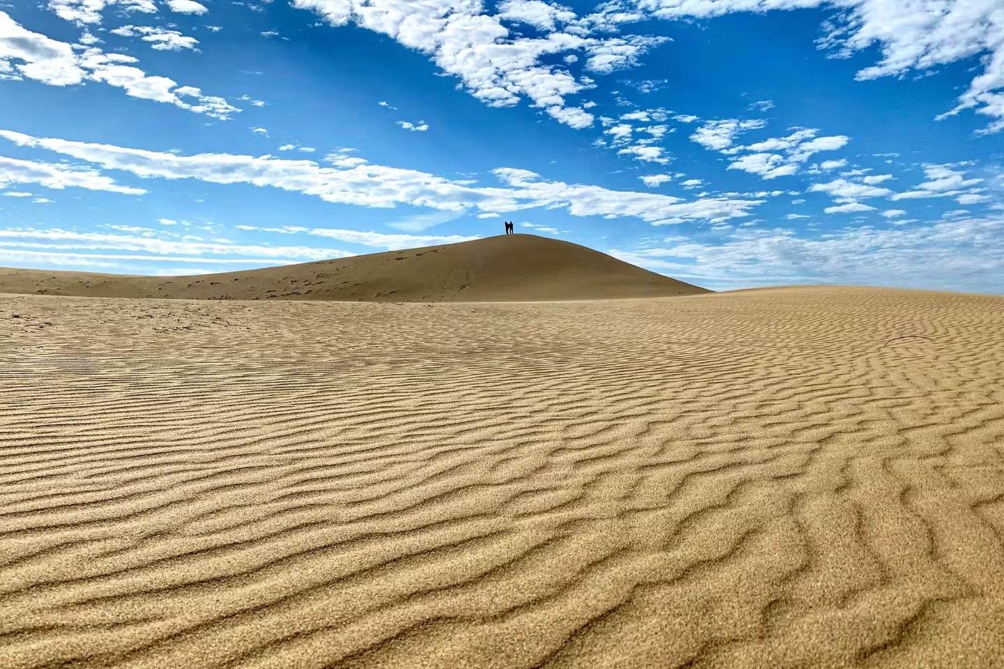 The contrast between the blue skies and the brown sand is stunning.