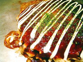 Okonomiyaki has less batter and cabbage remains crispy