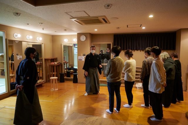 A Noh performer gives a tour of the backstage areas
