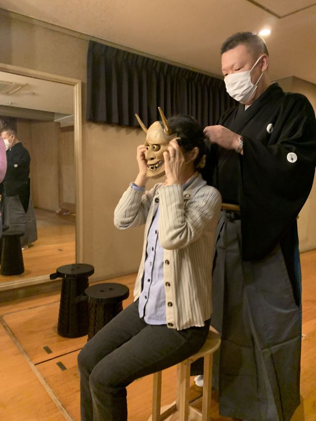 Trying on a Noh mask
