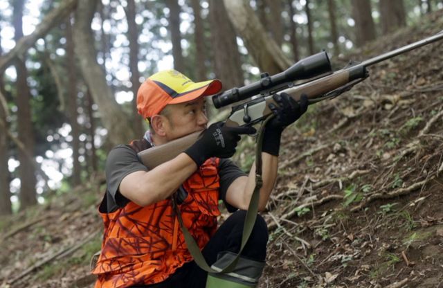 Gibier hunter Kentaro Nakajima with a hunting rifle