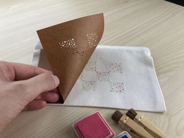 職人が彫った型紙とそれを使って染めたポーチ
IseKatagami Kyoudoukumiai(c)