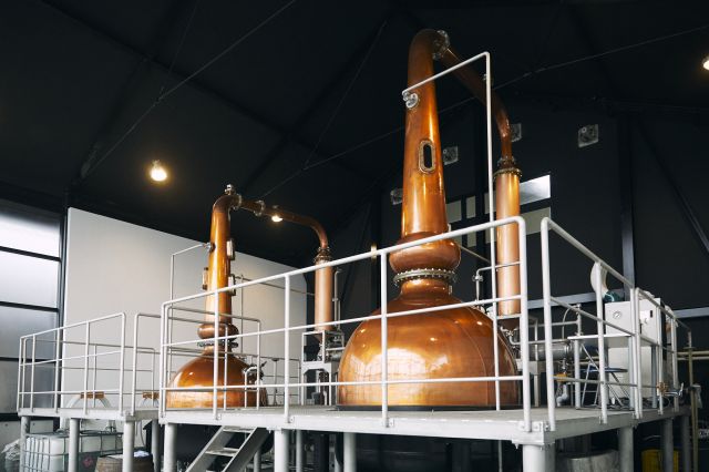 The interior of the Kaikyo distillery showing a copper distillation kettle where the whisky is prepared.